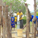 Community stakeholders from Lamoki village in Nwoya, Uganda get water from the borehole drilled by US water charity Drop in the Bucket
