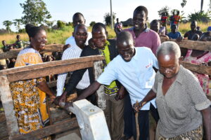 Community members from Nyapeya village in Uganda get safe water from the new well drilled by Drop in the Bucket