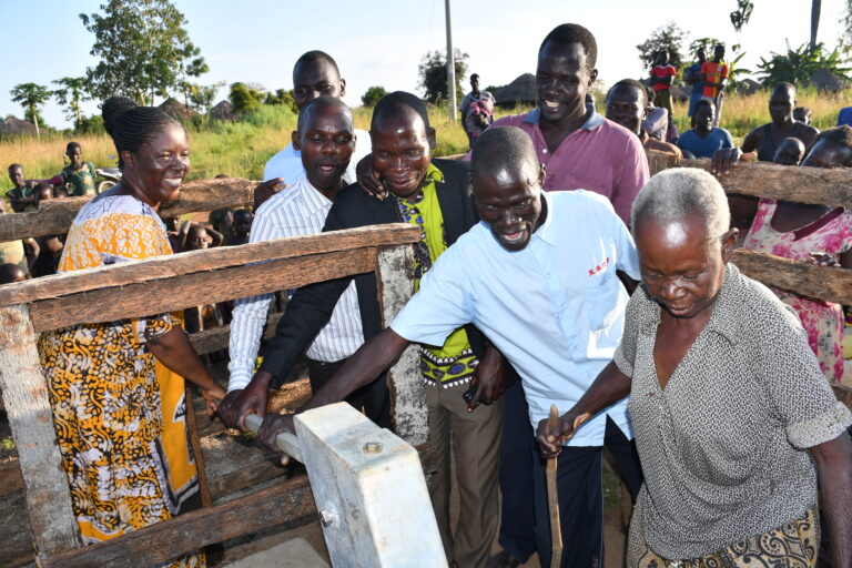 Community members from Nyapeya village in Uganda get safe water from the new well drilled by Drop in the Bucket