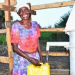 A woman from kalongak village in Gulu, Uganda gets clean water from the new well drilled by Drop in the Bucket