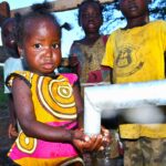 Children from kalongak village in Gulu, Uganda gets clean water from the new well drilled by Drop in the Bucket