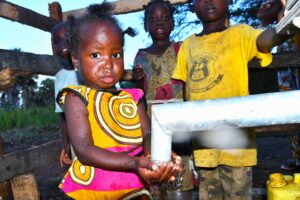 Children from kalongak village in Gulu, Uganda gets clean water from the new well drilled by Drop in the Bucket