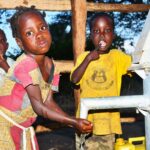 Children from kalngak village in Gulu, Uganda gets clean water from the new well drilled by Drop in the Bucket