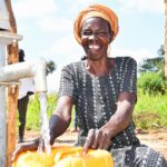 A woman from Patiri village in Nwoya, Uganda using the new well drilled by Drop in the Bucket