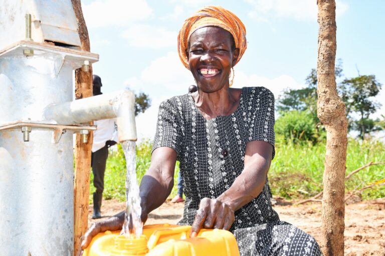 A woman from Patiri village in Nwoya, Uganda using the new well drilled by Drop in the Bucket
