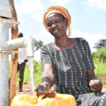 A woman from Patiri village in Nwoya, Uganda using the new well drilled by Drop in the Bucket