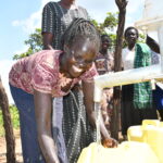 Community members from Patiri village in Nwoya, Uganda using the new well drilled by Drop in the Bucket