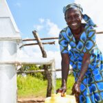 Woman filling a Jerrica with clean water at a well in Lakuny, Uganda