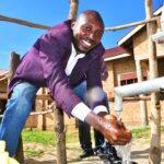 A woman gets clean water from a newly drilled well at the Diving Kingdom church in Omoro, Uganda