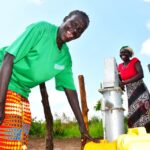 Community members from Tukupe community in Amuru, Uganda using the new well drilled by Drop in the Bucket