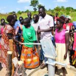 Community members from Tukupe community in Amuru, Uganda using the new well drilled by Drop in the Bucket