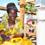 A woman from the Awornyim central community in Gulu, Uganda gets safe water from a new borehole 