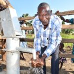 A man from the Awornyim central community in Gulu, Uganda gets safe water from a new borehole 