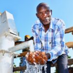 A man from the Awornyim central community in Gulu, Uganda gets safe water from a new borehole 