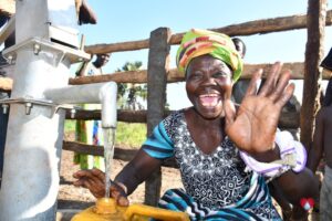 A woman from the Awornyim central community in Gulu, Uganda gets safe water from a new borehole drilled by Drop in the Bucket