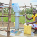 Young girl collecting clean water from a borehole well in Lakuny, Gulu, Uganda