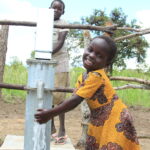lakuny-uganda-girl-using-water-well-africa