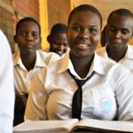 Students from the Gulu Central Secondary School study at their desks.