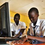 Students from the Gulu Central Secondary School study at their desks.