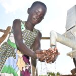 Getting clean water from the new water well in Baribari  in Amuru, Uganda