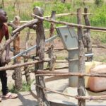 Getting clean water from the new water well in Opok village in Nwoya, Uganda