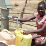 Getting clean water from the new water well in Opok village in Nwoya, Uganda