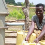 Getting clean water from the new water well in Opok village in Nwoya, Uganda