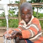 Getting clean water from the new water well in Awer in Amuru, Uganda