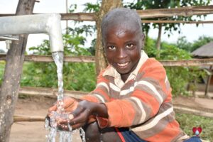 Getting clean water from the new water well in Awer in Amuru, Uganda