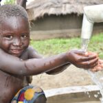 Getting clean water from the new water well in Awer in Amuru, Uganda