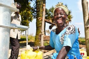 A woman from Loyoboo Lukome community getting clean water from the borehole in Gulu, Uganda