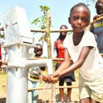 A girl gets clean water from the borehole at Rom village in Gulu, Uganda