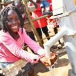A girl gets clean water from the borehole at Rom village in Gulu, Uganda