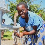 A child from Kal A 2 Ocega community, getting clean water from the borehole in Nwoya, Uganda