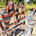 A man from Kal A 2 Ocega community, getting clean water from the borehole in Nwoya, Uganda