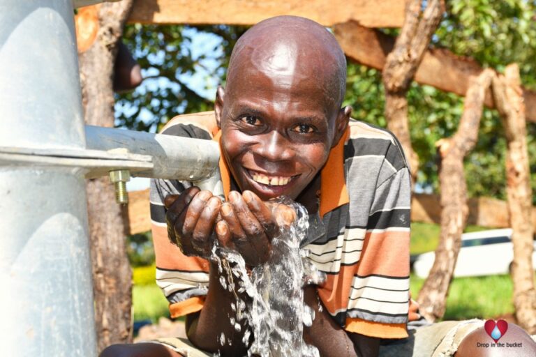 Drop in the Bucket Uganda water well Nwoya Kal A 2 Ocega Koch Goma borehole12 - Drop In the Bucket A man from Kal A 2 Ocega community, getting clean water from the borehole in Nwoya, Uganda