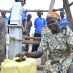 Community members from Lakwatomer-Korga-community, getting clean water from the borehole in Koro, Omoro, Uganda