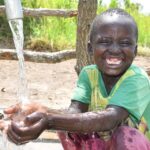 A child from Lakwatomer-Korga-community, getting clean water from the borehole in Koro, Omoro, Uganda