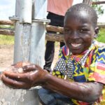 A child from Lakwatomer-Korga-community, getting clean water from the borehole in Koro, Omoro, Uganda