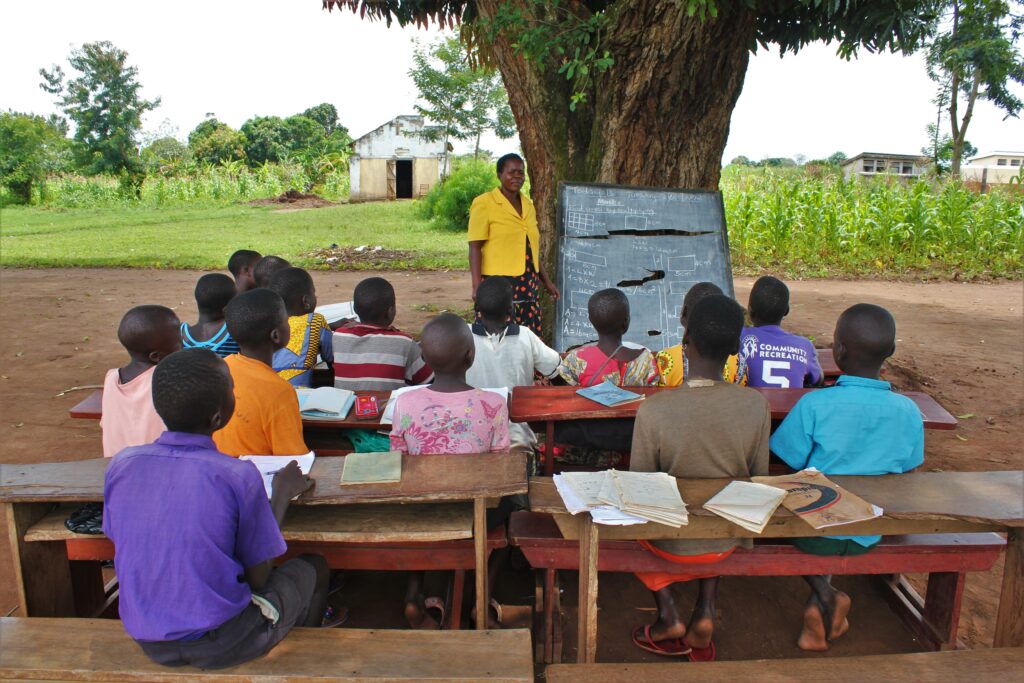 Children studying under trees at the Mwendanfuko primary school in Iganga, Uganda