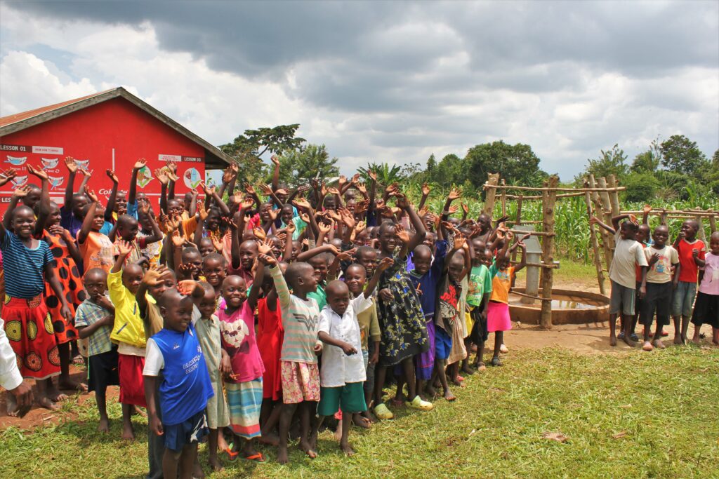 Excited children at the Mwendanfuko primary school in Iganga, Uganda celebrating clean water and education.