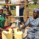 Women from the Ated Wrot village in Nwoya, Uganda get clean water from the well recently drilled by Drop in the Bucket