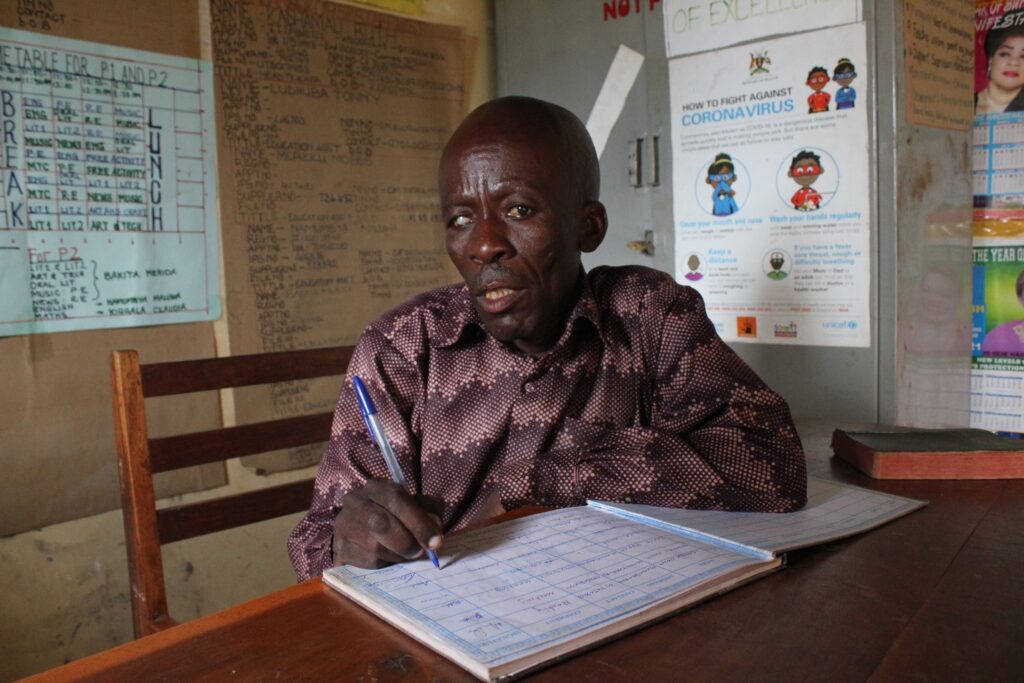 Kakubo George headteacher from the Mwendanfuko primary school in Iganga, Uganda sits at the desk in his office.
