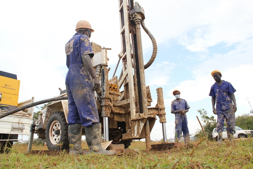 Drop in the Bucket drillers working on a water well in Uganda