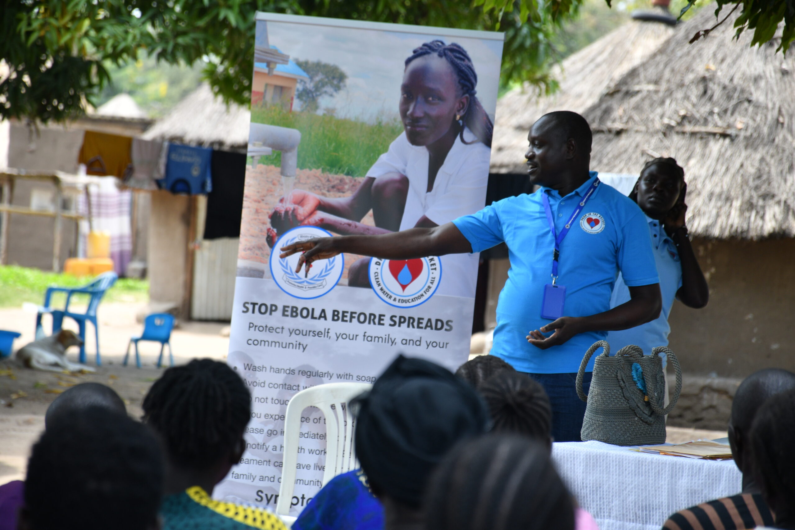 Drop in the Bucket staff talking to community members about the Ebola virus and how to prevent its spread.