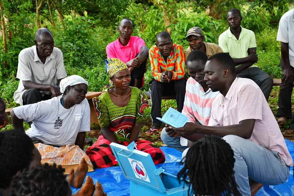 Drop in the Bucket staff meets with a water management committee in Gulu, Uganda