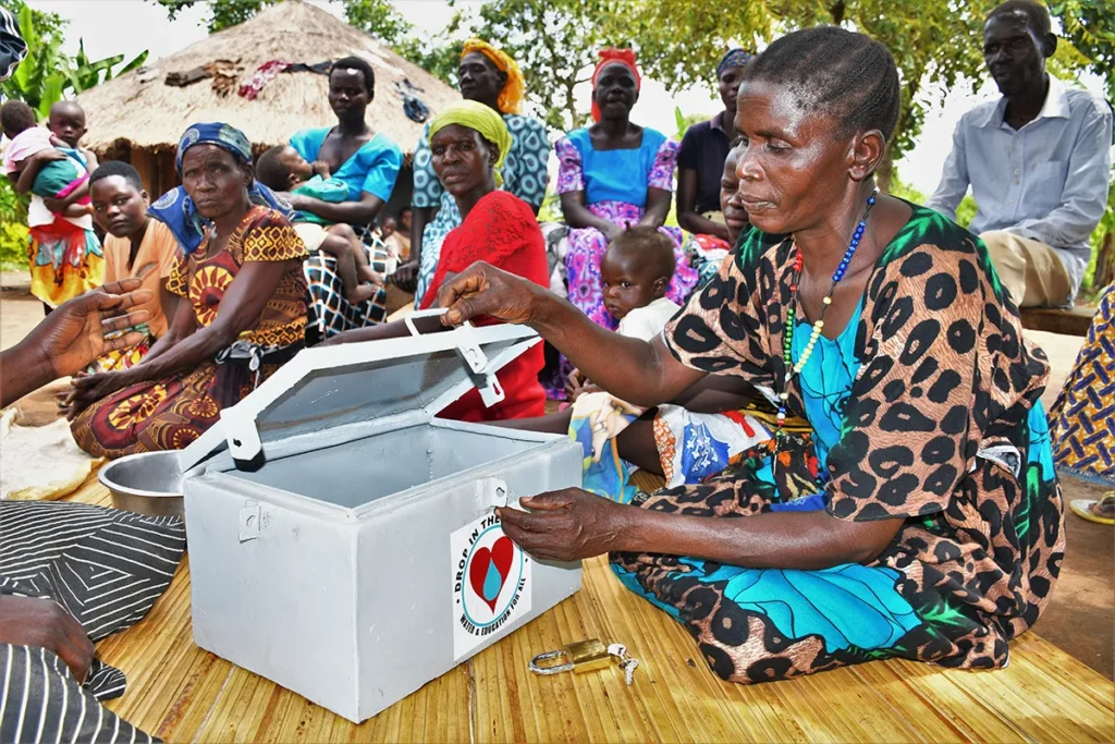 Community members meet for a Village savings and loan association meeting (VSLA) in Uganda