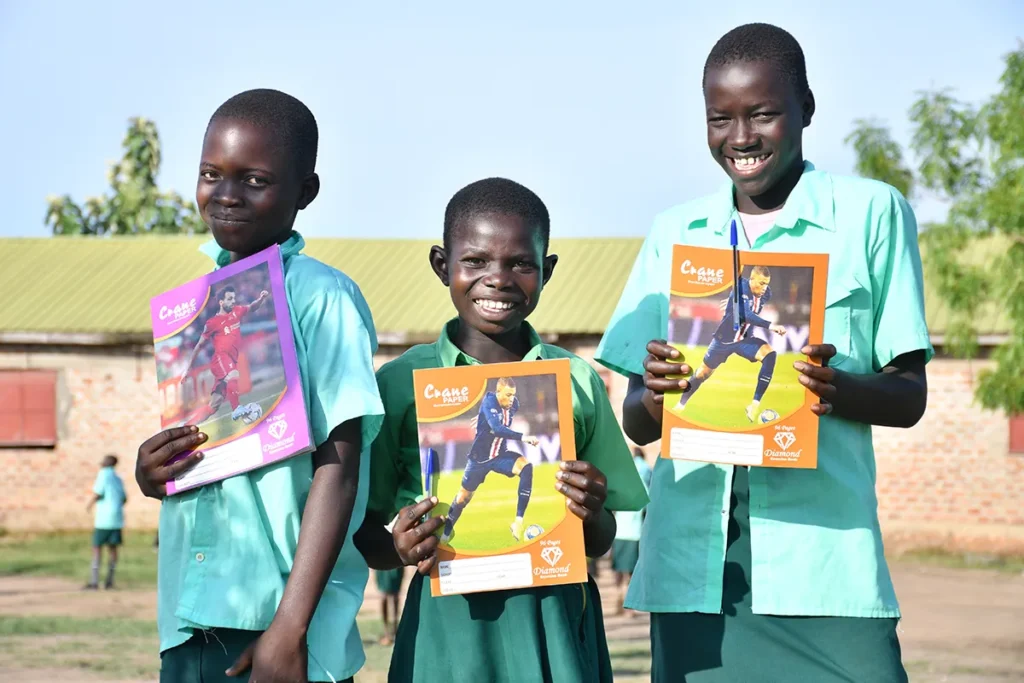 Three students from Green Valley Primary School attending a Safe Space after-school class in South Sudan