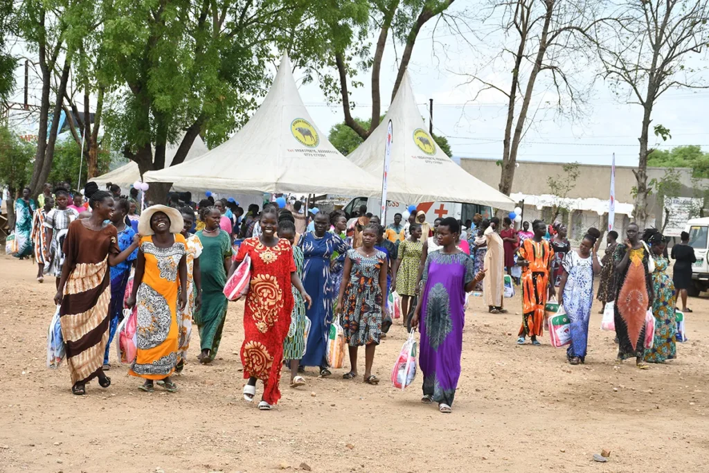 Expectant mothers carrying Mama Kits after a workshop in Nimule, South Sudan