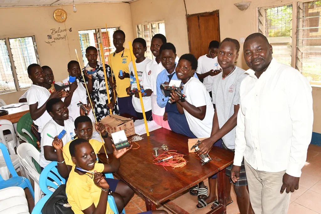 A teacher leads a science class of girls during a coaching session in Niumle South Sudan